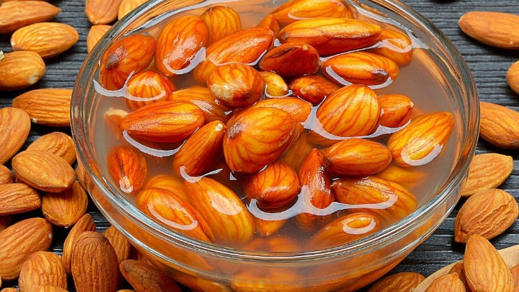 almonds soaking in clear bowl of water